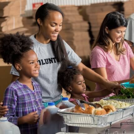 family serving food at a food drive